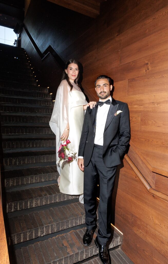a newly wed husband and wife on the stairs of Matilda Restaurant in South Yarra