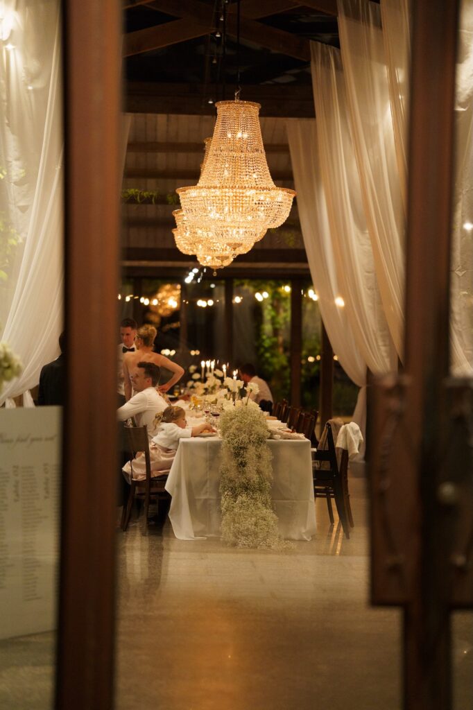 evening reception table with a chandelier at Stones of the Yarra Valley